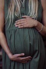 close up of green pregnancy dress